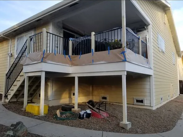 Covered deck masked with paper and tape before exterior painting